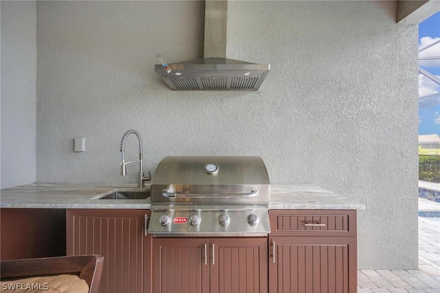 view of patio with area for grilling and sink