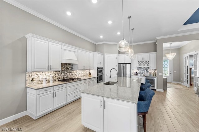 kitchen with appliances with stainless steel finishes, wine cooler, premium range hood, and white cabinetry