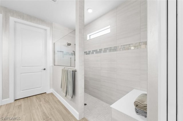 bathroom with a tile shower