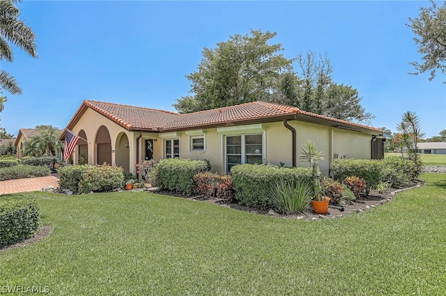 mediterranean / spanish-style house with a front yard