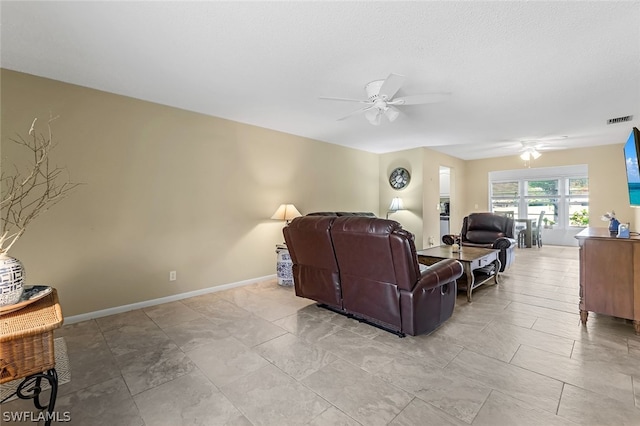 living room featuring tile flooring and ceiling fan