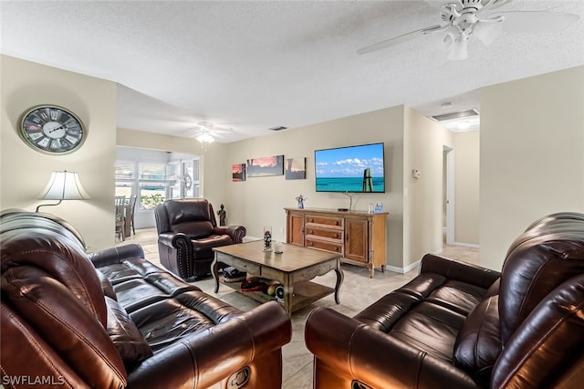 tiled living room featuring ceiling fan and a textured ceiling