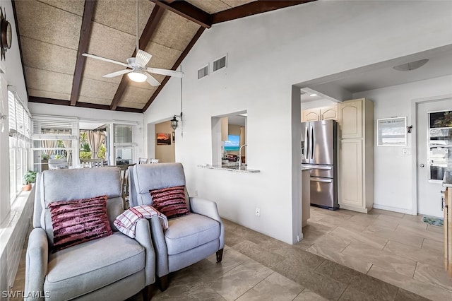 living room with high vaulted ceiling, ceiling fan, beam ceiling, and light tile flooring