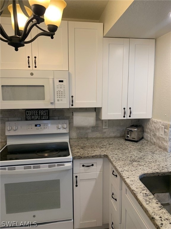 kitchen with sink, white cabinetry, light stone counters, tasteful backsplash, and white appliances