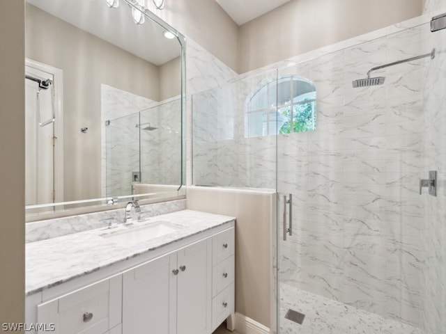 bathroom featuring vanity and an enclosed shower