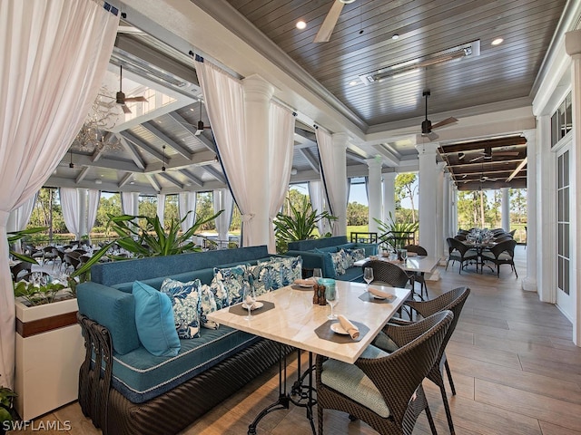 sunroom featuring ceiling fan and wood ceiling