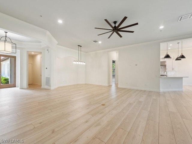 unfurnished living room featuring ceiling fan, plenty of natural light, and light wood-type flooring