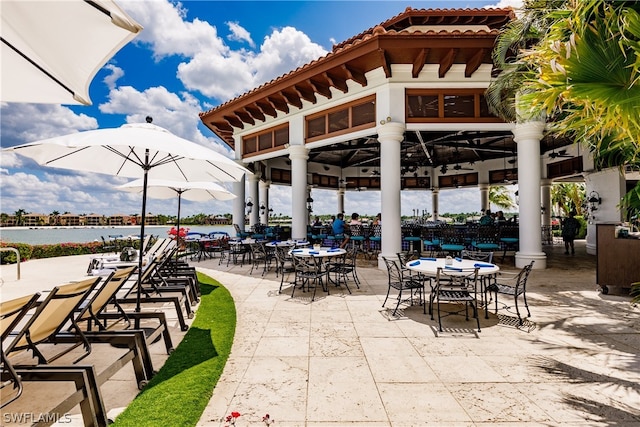 view of patio featuring a water view and a gazebo