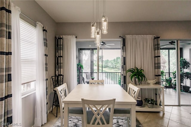 dining room with a wealth of natural light, ceiling fan, and light tile flooring