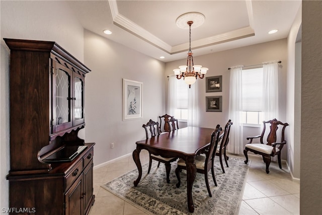 tiled dining room with a notable chandelier and a tray ceiling