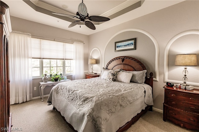 bedroom featuring carpet, ceiling fan, and a raised ceiling