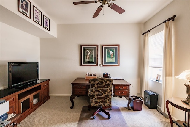 carpeted office space with ceiling fan