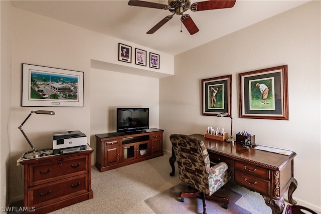 carpeted home office featuring ceiling fan