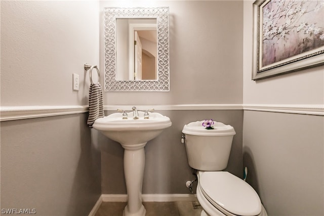 bathroom featuring toilet and tile floors