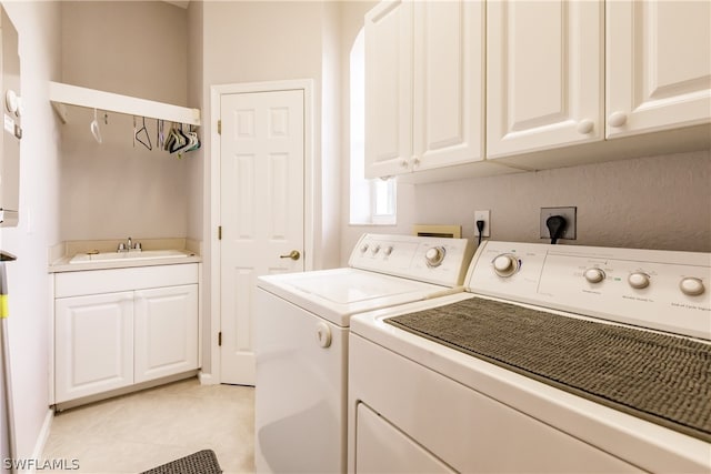 laundry room with independent washer and dryer, cabinets, light tile flooring, electric dryer hookup, and sink