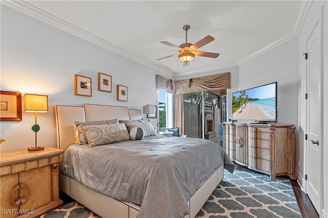 bedroom with ornamental molding, ceiling fan, and dark wood-type flooring