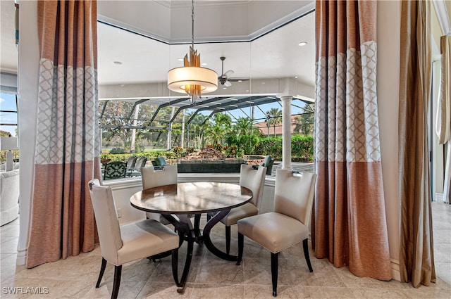 dining area featuring decorative columns, ceiling fan, and a healthy amount of sunlight