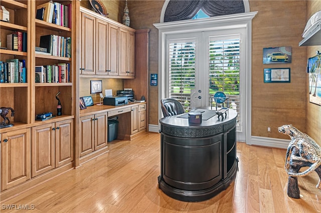 office area with light wood-type flooring and built in desk