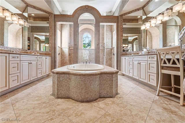 bathroom featuring vanity, a relaxing tiled tub, tile patterned floors, and crown molding