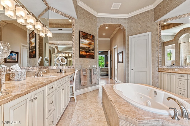 bathroom with tiled bath, vanity, and ornamental molding