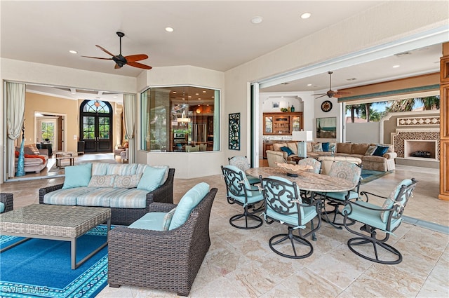 living room with ceiling fan and crown molding