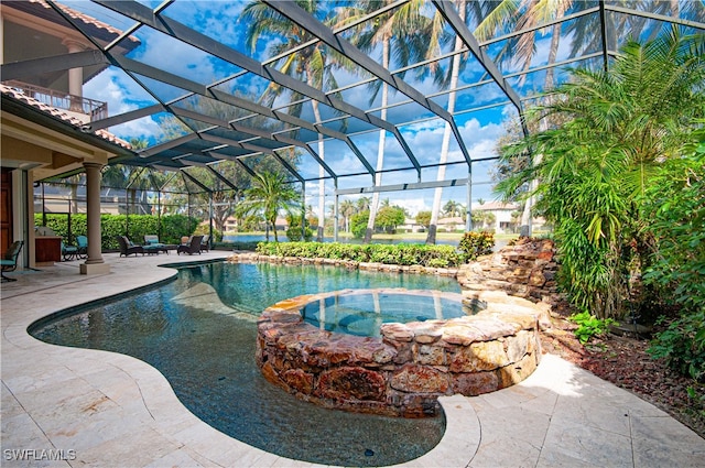 view of swimming pool featuring a lanai, an in ground hot tub, and a patio