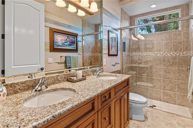 bathroom with tile patterned flooring, a shower with door, vanity, and toilet