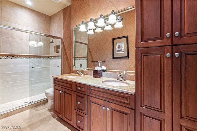 bathroom with tile patterned floors, vanity, toilet, and an enclosed shower