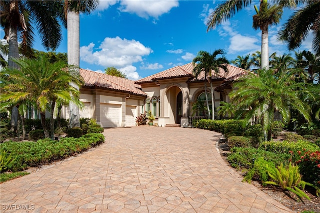 mediterranean / spanish home with a garage