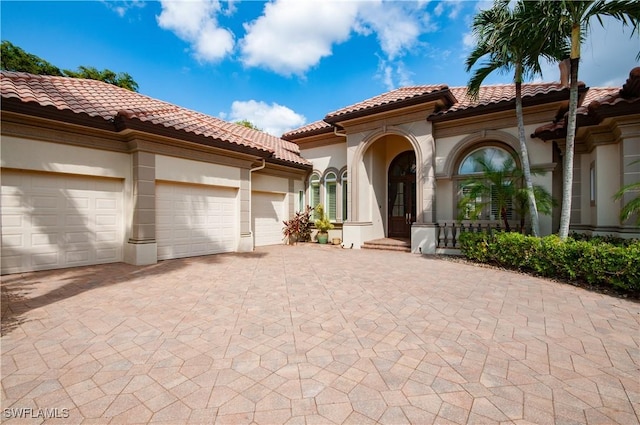 mediterranean / spanish-style house with a garage