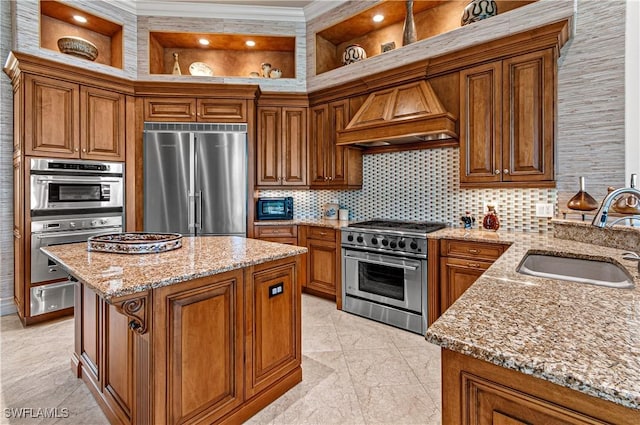 kitchen with premium range hood, tasteful backsplash, sink, premium appliances, and light stone counters