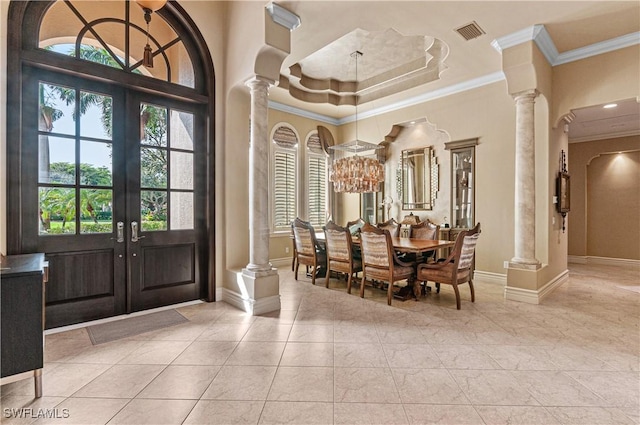 entrance foyer with decorative columns, crown molding, a healthy amount of sunlight, and french doors