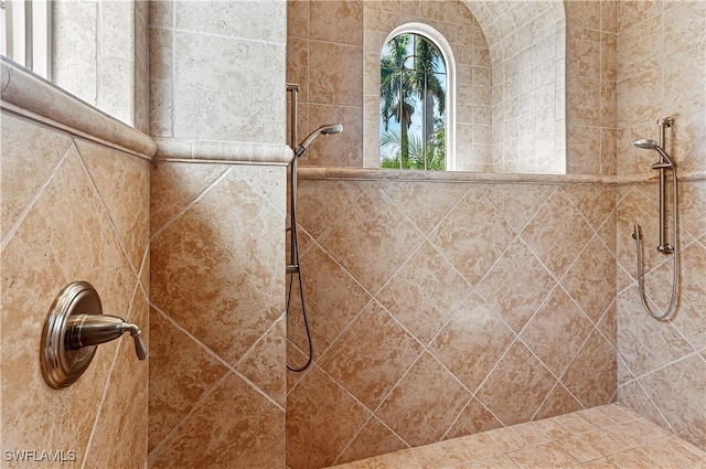 bathroom with tiled shower