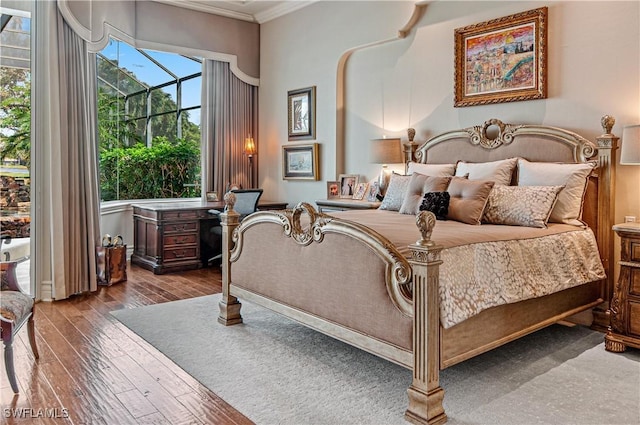 bedroom with wood-type flooring and ornamental molding