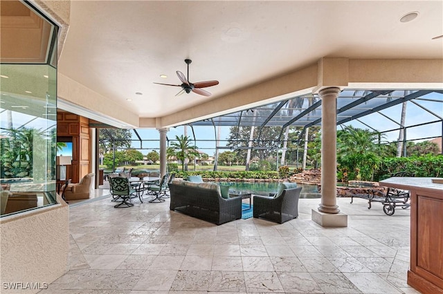 view of patio with ceiling fan, outdoor lounge area, and glass enclosure