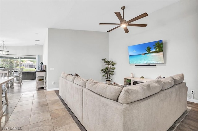 living room with tile patterned flooring, lofted ceiling, and ceiling fan