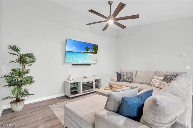 living room featuring hardwood / wood-style flooring and ceiling fan