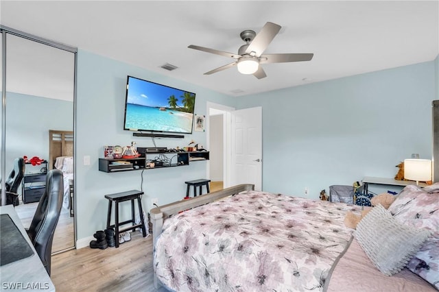 bedroom featuring light hardwood / wood-style floors, a closet, and ceiling fan