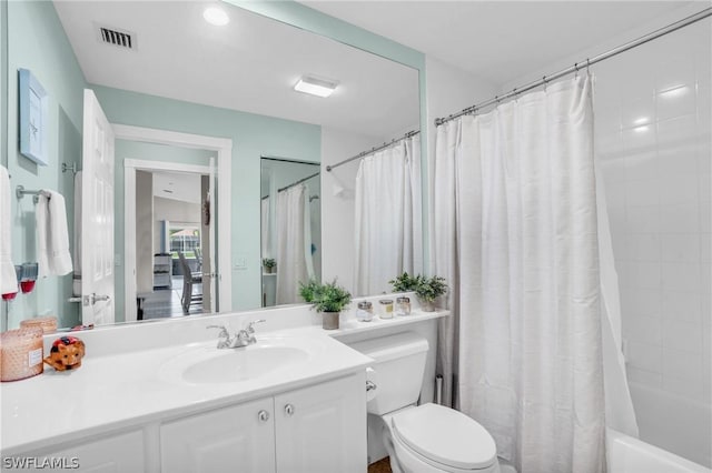 full bathroom featuring vanity, toilet, and shower / bath combo with shower curtain