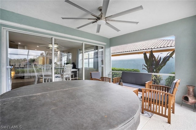 sunroom / solarium with ceiling fan