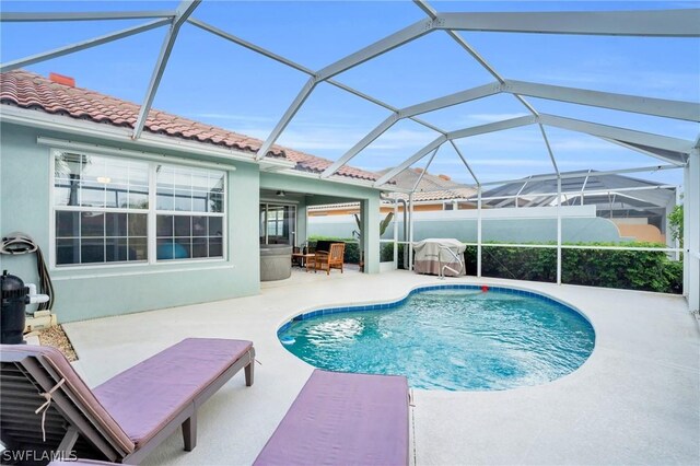 view of pool featuring a patio, a lanai, and grilling area