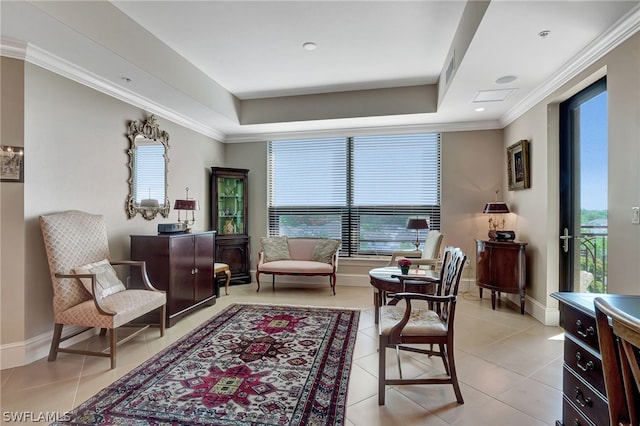 living area with a tray ceiling, ornamental molding, and light tile patterned flooring