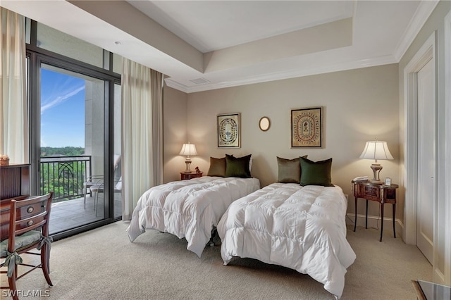 carpeted bedroom with ornamental molding, a raised ceiling, and access to outside