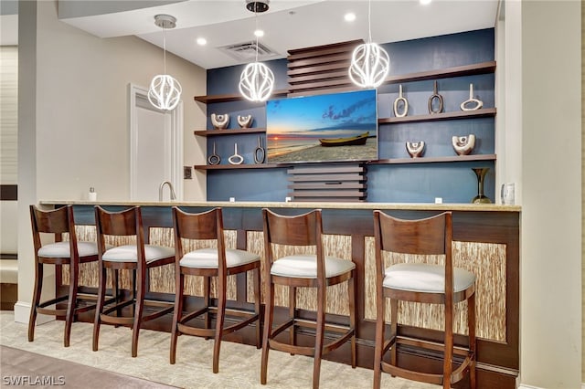 bar with hanging light fixtures and sink