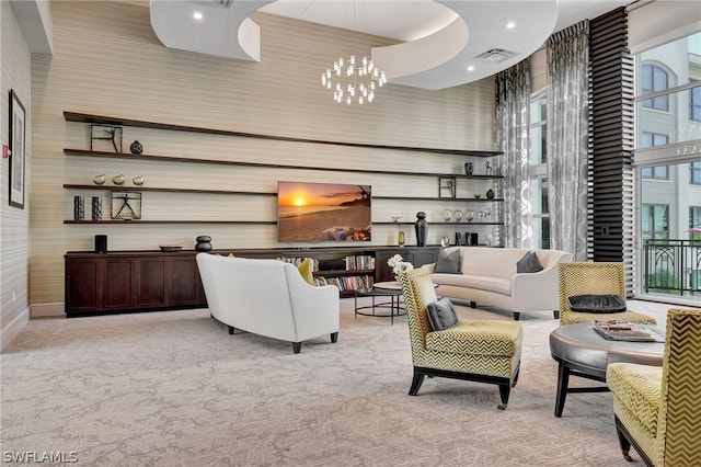 living room featuring light carpet and a chandelier