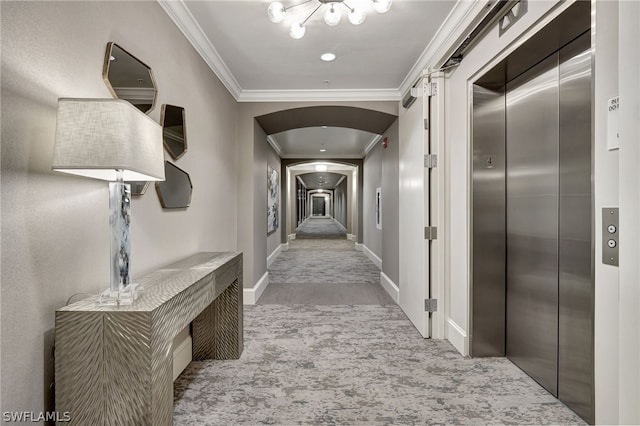 corridor with ornamental molding and elevator