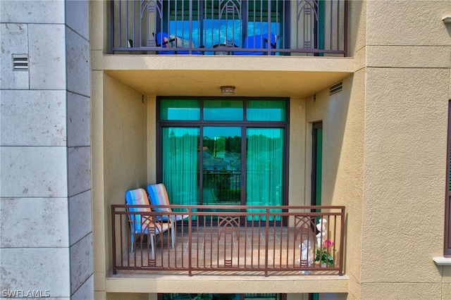 entrance to property with a balcony