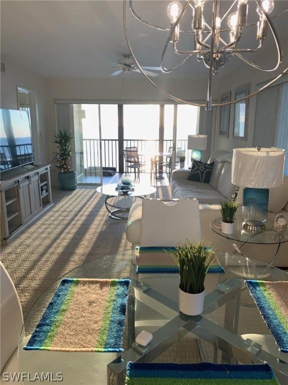 living room featuring carpet, plenty of natural light, and ceiling fan