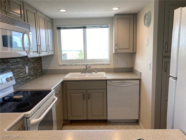 kitchen with white appliances, sink, decorative backsplash, gray cabinets, and light tile patterned floors