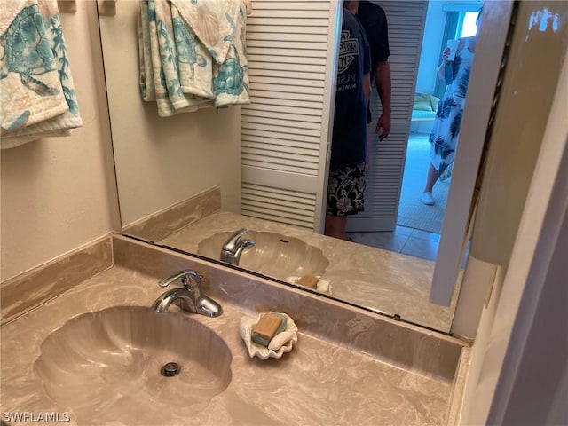 bathroom featuring tile patterned flooring and vanity